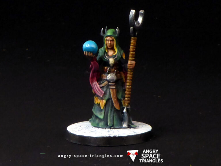 Painted fantasy miniature sorceress in green